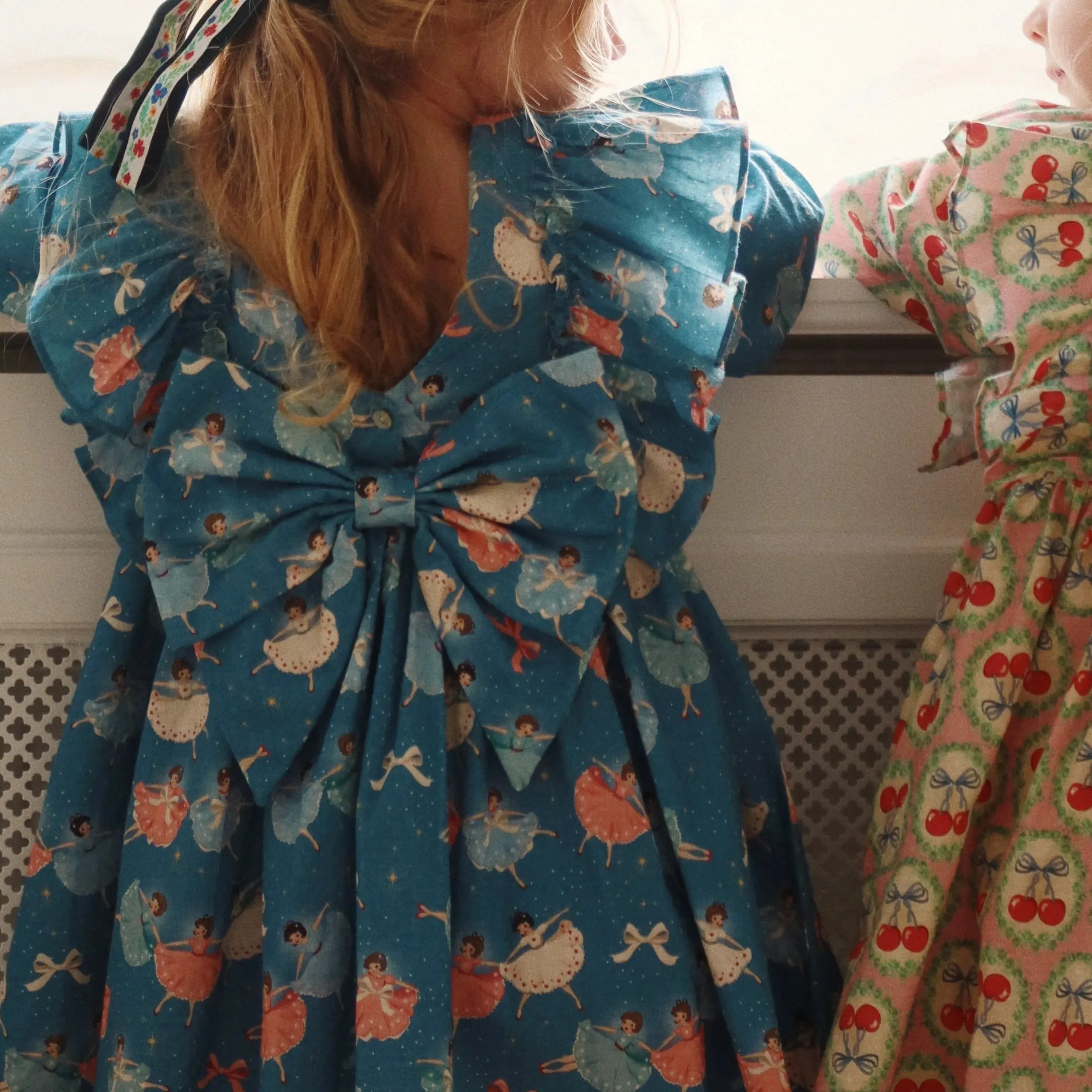 Evia Bow Ballerina Print Long Sleeve Ruffle Dress